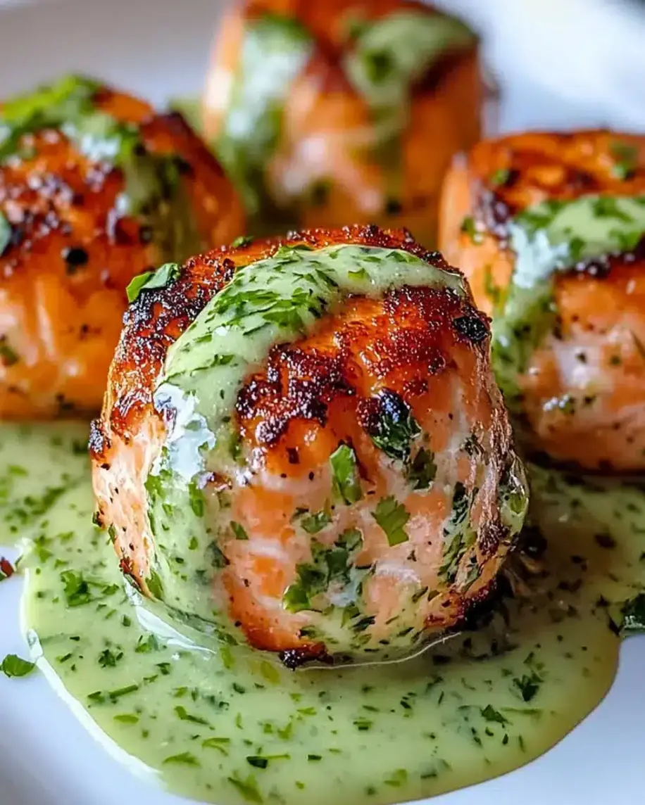 Salmon balls with creamy avocado sauce served on a platter.