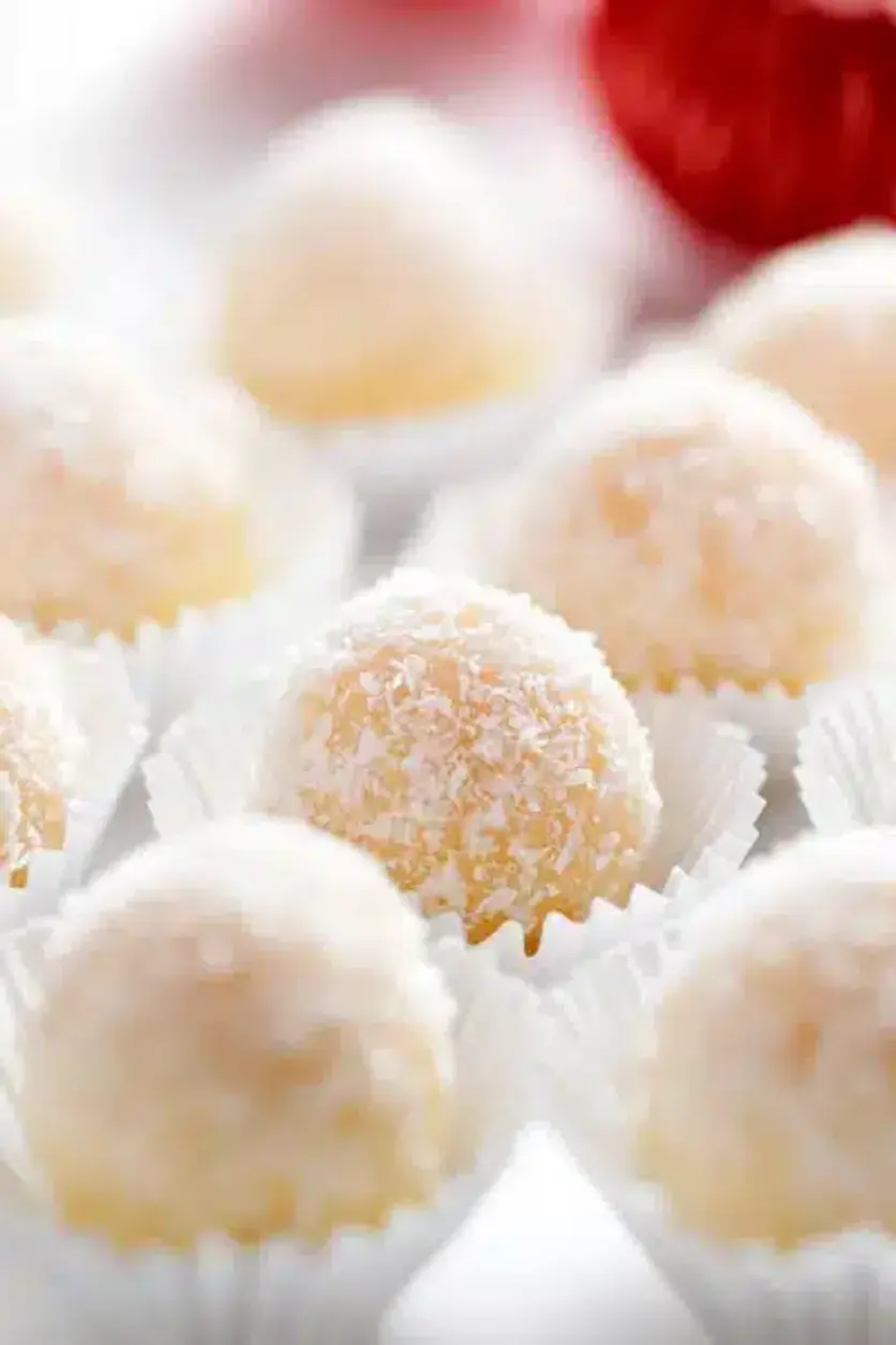 Snowball Coconut Fudge Truffles with a bite taken out