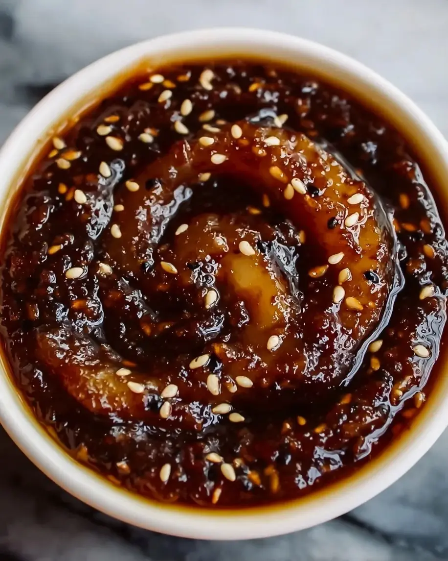 Honey Teriyaki Dressing Recipe in a glass jar with a spoon, ready to be drizzled.