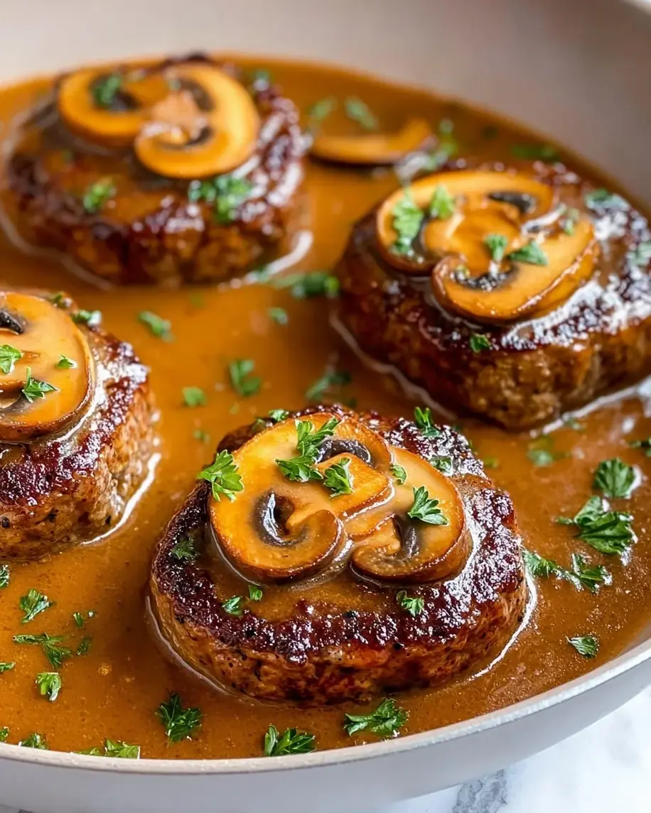 Easy Homemade Salisbury Steak Recipe with savory mushroom gravy served over mashed potatoes.