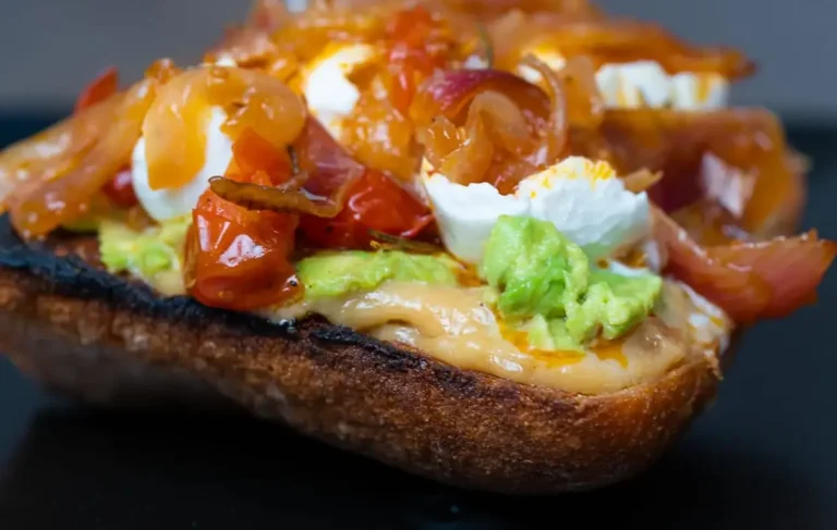 Avocado toast with slow roasted garlic, tomatoes and caramelized onions